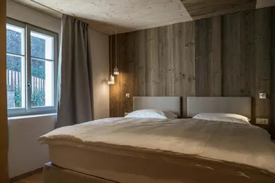 a bedroom with a large bed and a window at Ansitz Pontegardena in Ponte Gardena