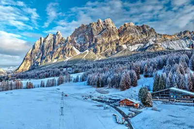 a view of a snow covered mountain with lights at Casa Guargnè in Cortina dʼAmpezzo