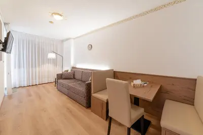 a living room with a table and a couch at Apartment with Sauna at Pineta Pastry in Sottoguda