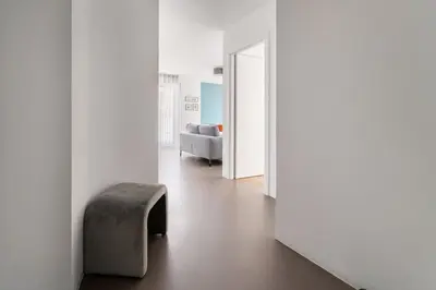 a living room with a chair and a couch at Heart Apartment in Merano