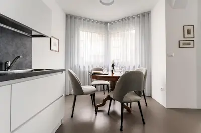 a kitchen with a table and chairs and a window at Heart Apartment in Merano