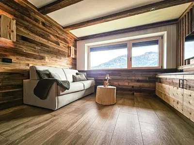 a living room with a couch and a window at Ciasa Sotiac in Antermoia