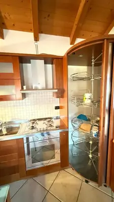 a kitchen with a stove top oven in a kitchen at Appartamento Villa Nicole in Transacqua
