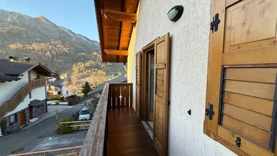 a balcony of a house with a view of a mountain at Appartamento Villa Nicole in Transacqua