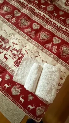 two white towels are sitting on a bed at Appartamento Villa Nicole in Transacqua