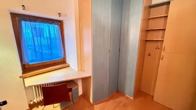 a room with a window and a desk with a radiator at Appartamento Villa Nicole in Transacqua