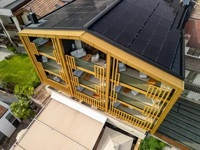an overhead view of a building with solar panels on its roof at Alea Living in Tirolo