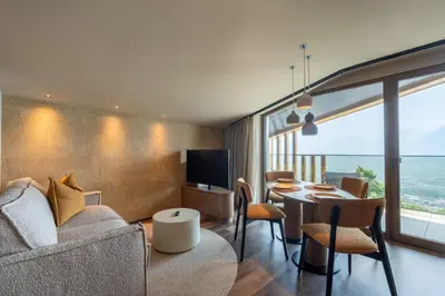 a living room with a couch and a table at Alea Living in Tirolo