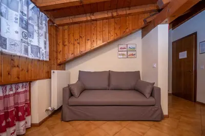 a living room with a couch in a room at Casa Falcade in Falcade