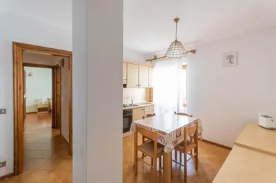 a kitchen with a table and a dining room at Casa Falcade in Falcade