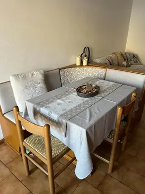 a table and chairs with a plate on top of it at Appartamento Cuore delle Dolomiti in Cencenighe