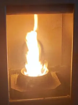 a lit candle in a box in a room at Appartamento Cuore delle Dolomiti in Cencenighe