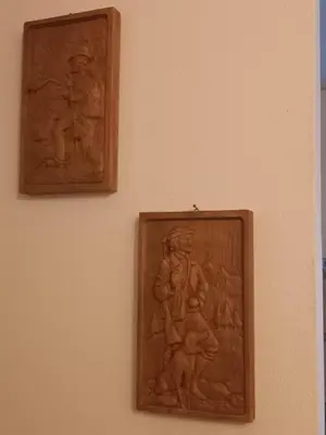 two woodenaques on the wall of a museum at Appartamento Cuore delle Dolomiti in Cencenighe