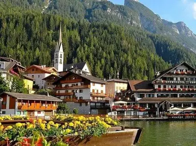 a town with a church and a river with buildings at Appartamento Cuore delle Dolomiti in Cencenighe