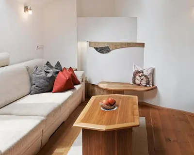 a living room with a couch and a table at Apartment Schmetterling in Collalbo