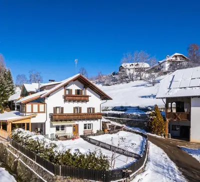 a house in the snow with a fence at Apartment Schmetterling in Collalbo