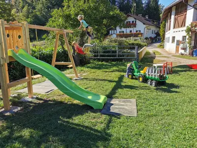 a child playing on a playground with a slide at Apartment Schmetterling in Collalbo