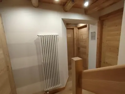 a staircase in a house with wooden floors at Gianni Rocca Apartments APPARTAMENTO PIANO 1 E 2 in Rocca Pietore