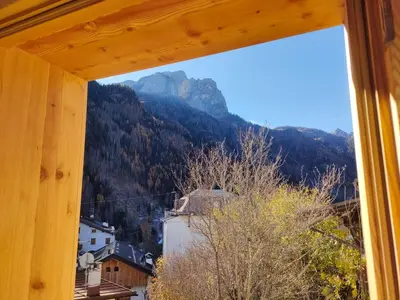 a view of a mountain from a window at Gianni Rocca Apartments APPARTAMENTO PIANO 1 E 2 in Rocca Pietore