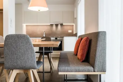a kitchen and dining room with a table and chairs at Moderne panorama Apartments in den Dolomiten, 2min von den Liften in Selva di Val Gardena