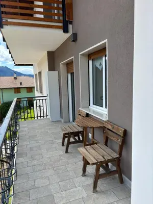 a balcony with two benches and a window at Casa GOLLES - Val Di Fiemme in Castello di Fiemme