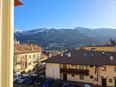 a view of a city with cars parked in a parking lot at Casetta sui Monti - Alpine Stay Apartments in Tesero