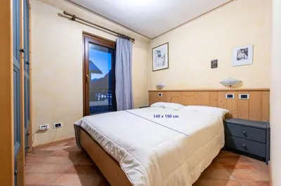 a bedroom with a large bed in a room at Cesa Malvi in Canazei