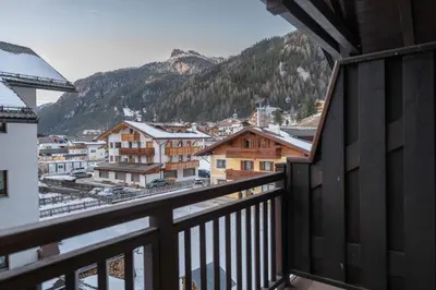 a balcony with a view of a town and mountains at Cesa Malvi in Canazei