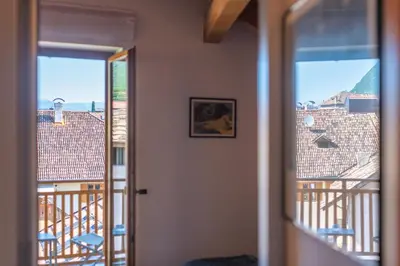a room with a view of a balcony at Maison sous le ciel in Caldaro