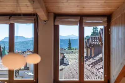a view from a window of a building with mountains at Maison sous le ciel in Caldaro