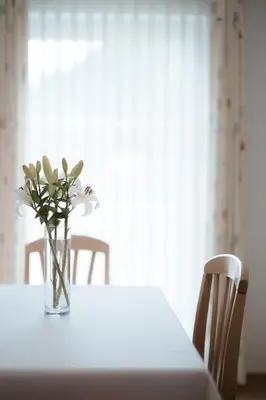 a vase of flowers sitting on top of a table at Apartment Hotel Elvis in Ortisei