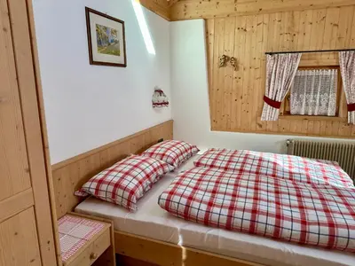 a bed with two pillows in a small room at Scurcia in Ortisei