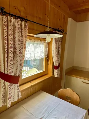 a bedroom with a window with curtains and a bed at Scurcia in Ortisei