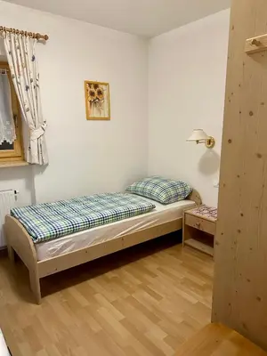 a bedroom with a bed in the corner of a room at Scurcia in Ortisei