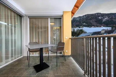 a balcony with a table and chairs on it at Residence Petlin Filip in Ortisei