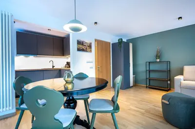 a kitchen and a dining room with a table and chairs at Residence Petlin Filip in Ortisei