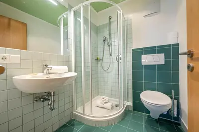 a bathroom with a sink and a toilet and a shower at Residence Petlin Filip in Ortisei