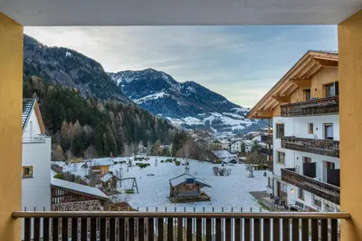 a view from a balcony of a town in the mountains at Residence Petlin Filip in Ortisei