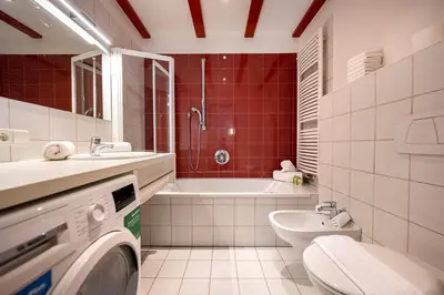 a bathroom with a toilet sink and a washing machine at Residence Petlin Filip in Ortisei