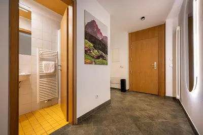 a hallway with a bathroom with a door at Residence Petlin Robert in Ortisei