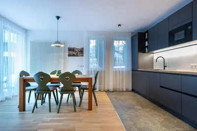 a kitchen with a dining room table and chairs at Residence Petlin Robert in Ortisei