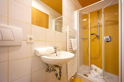 a bathroom with a sink and a shower at Residence Petlin Robert in Ortisei
