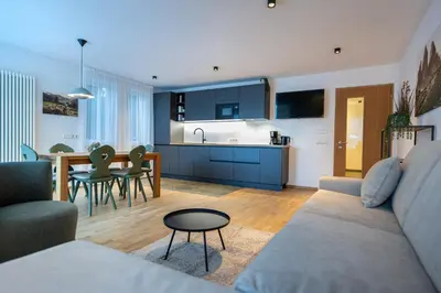 a kitchen and living room with a couch and a table at Residence Petlin Robert in Ortisei