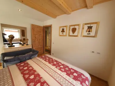 a bedroom with a large bed in a room at Casa Sandra Moena by Go new Location in Moena