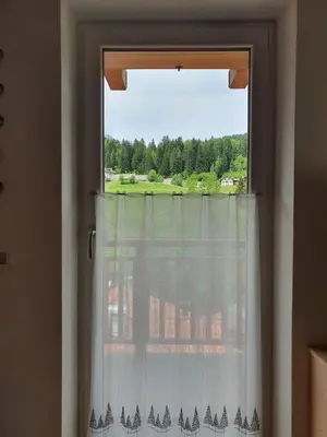 a window with a view of a field at Casa Sandra Moena by Go new Location in Moena