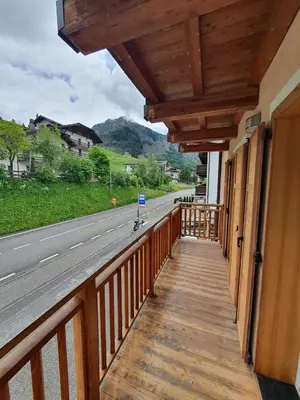 a balcony of a house with a view of a road at Casa Sandra Moena by Go new Location in Moena