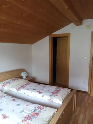a bedroom with a bed and a wooden ceiling at Ausserstauderhof in San Leonardo in Passiria