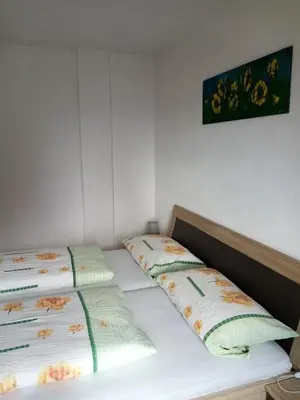 two twin beds in a room with a picture on the wall at Ausserstauderhof in San Leonardo in Passiria