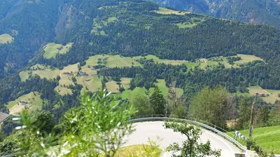 a bridge over a road on a mountain at Ausserstauderhof in San Leonardo in Passiria