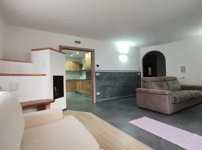 a living room with a couch and a chair at Casa Elisa apartment in Ronzone